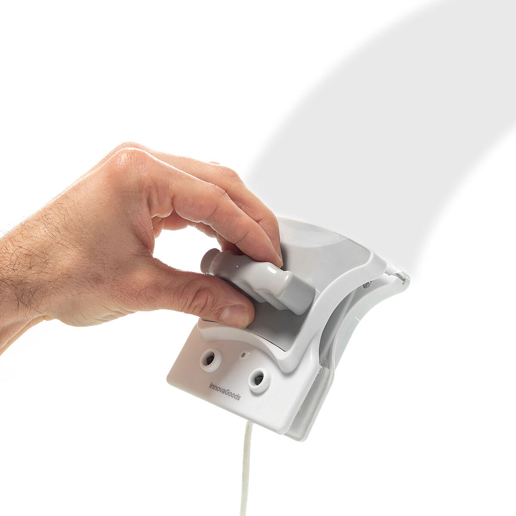 Close-up of a hand gripping the Magnetic Window Cleaner, demonstrating its ergonomic design and ease of use on glass surfaces.