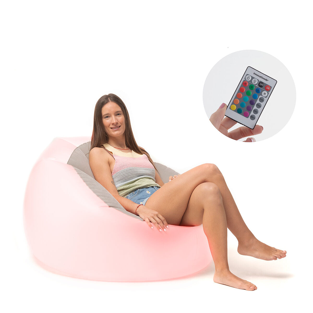 A woman sitting on a pink-glowing inflatable armchair with a remote control displayed in detail. The focus is on both comfort and control over the lighting.