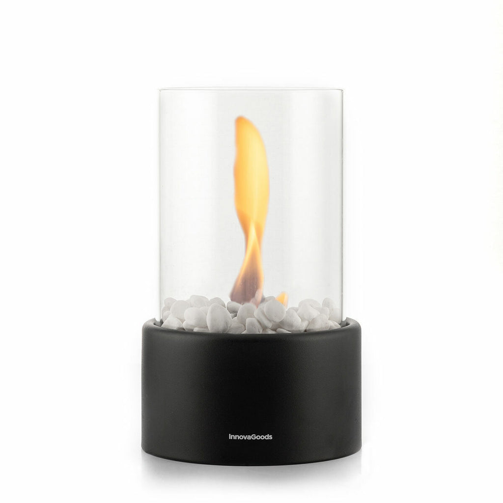 Product shot of the fireplace with a visible flame inside the glass cylinder, presenting the aesthetic appeal when lit.