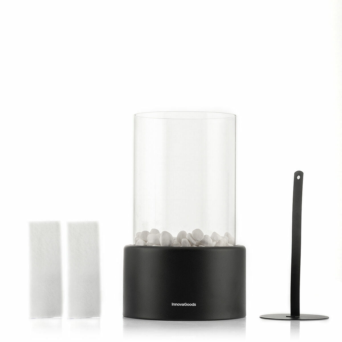 The tabletop fireplace shown with additional components including two white filters and a metal snuffer, emphasizing the product's accessories.
