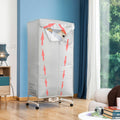 The InnovaGoods Portable Electric Dryer in a living room setting with wooden floors and blue walls. The silver fabric dryer cover is mounted on a frame with wheels, showcasing red arrows indicating air flow. It contains hangers with shirts visible through the top opening.