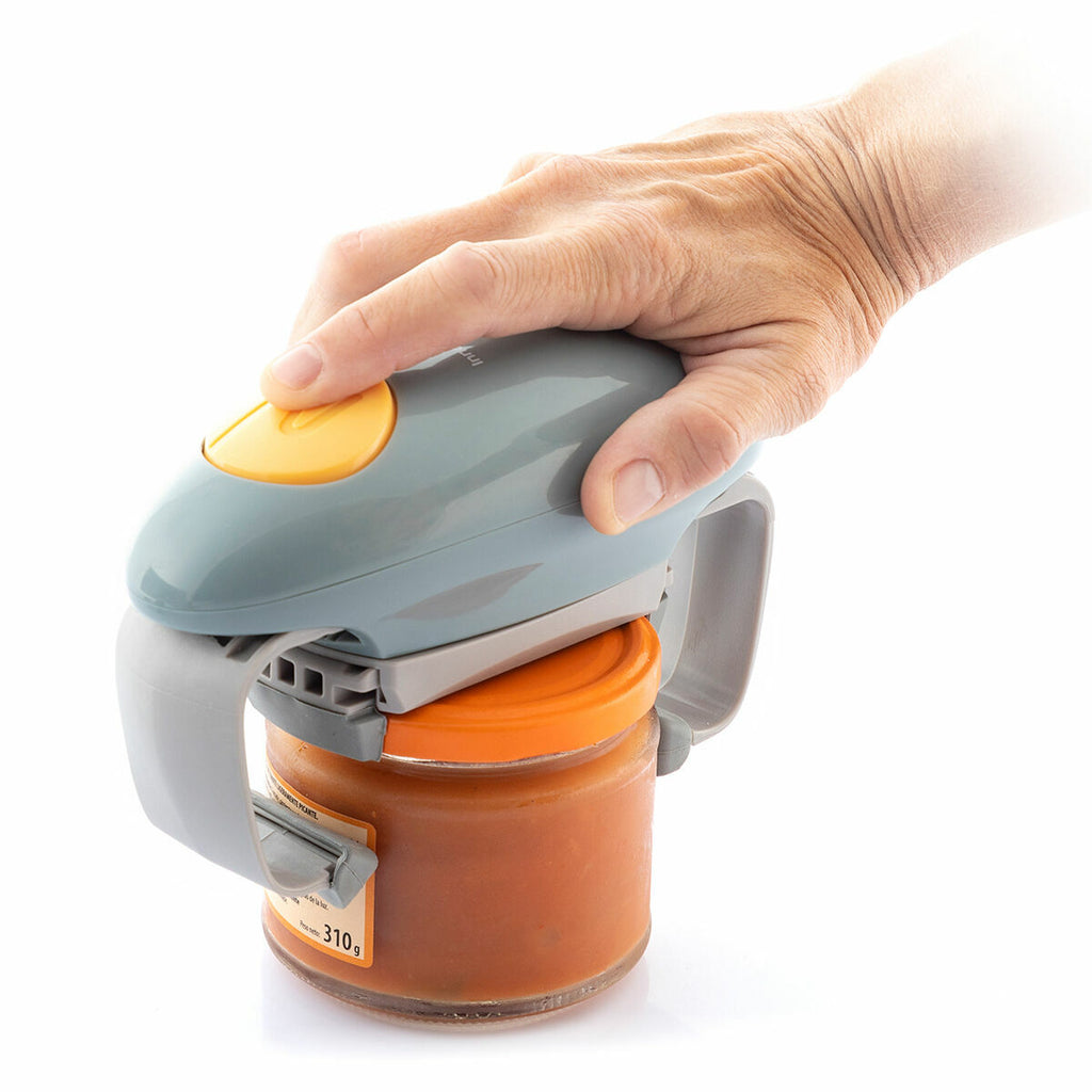 The Electric Jar Opener Lloucan InnovaGoods with a hand pressing the yellow button firmly on an orange-capped jar, illustrating ease of use and functionality in a kitchen setup.