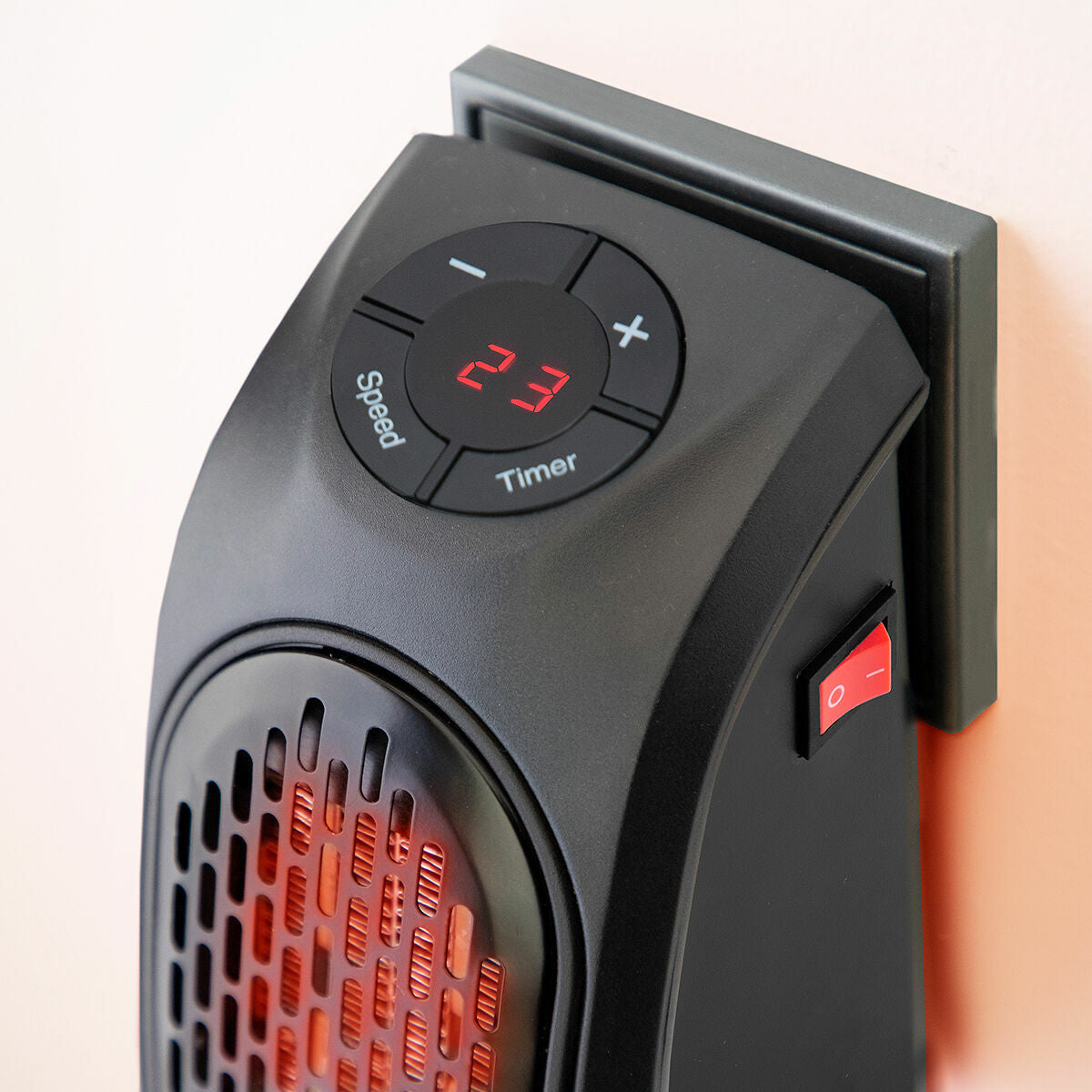 Close-up of the digital display and settings of the heater plugged into a wall, illustrating user interface elements.