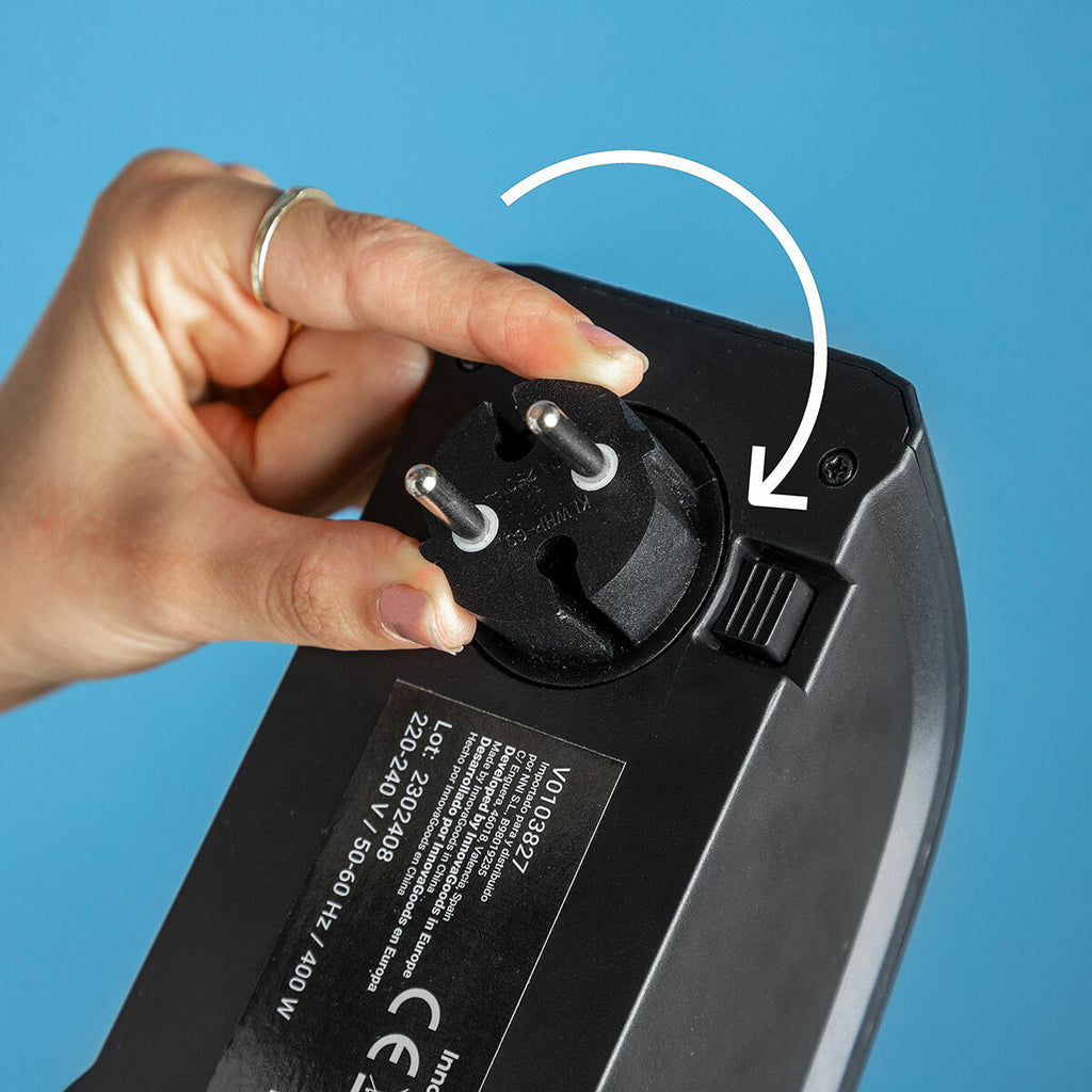 Close-up of a hand rotating the plug showing the adaptability to different plug orientations.