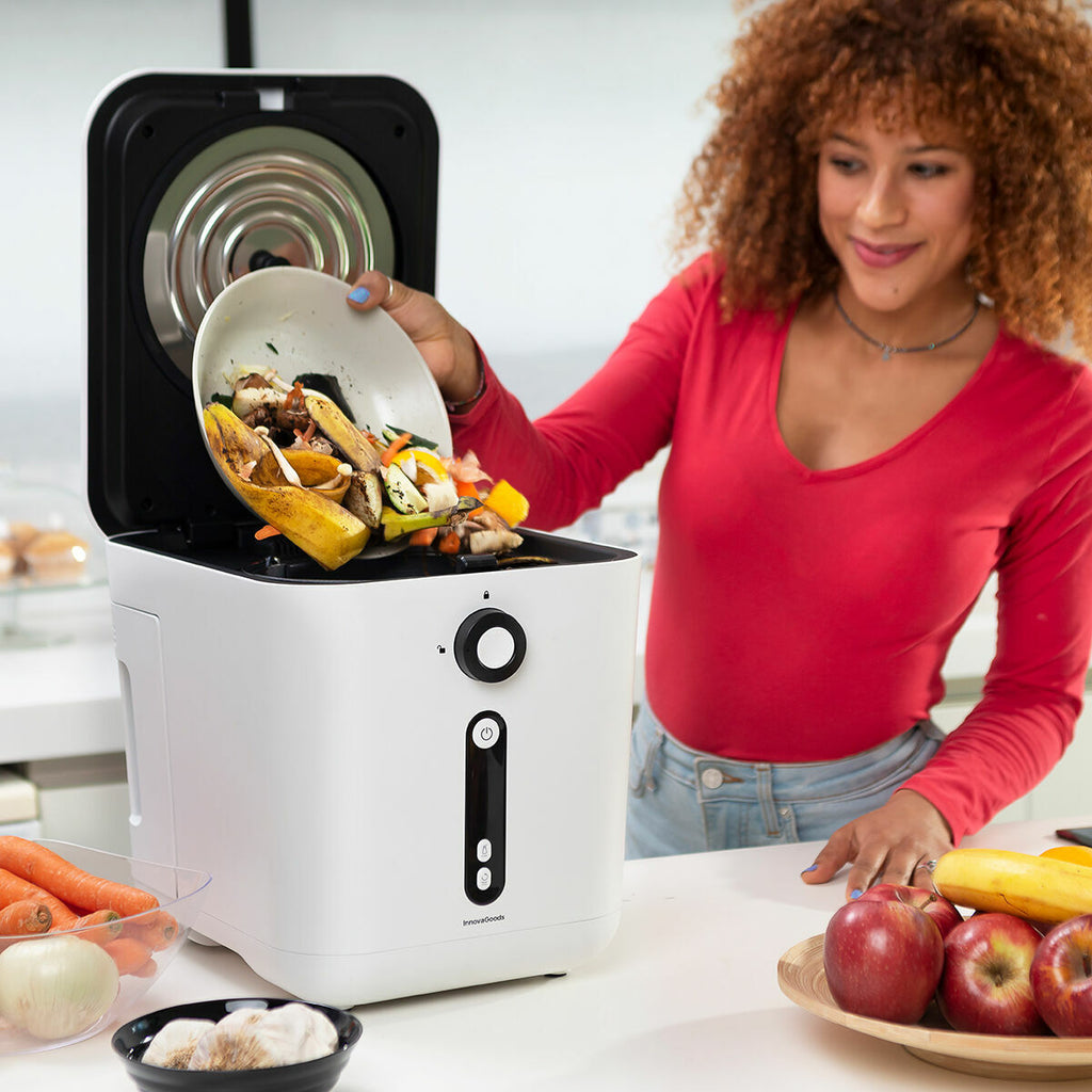 A woman is using the Ewooster electric composter in a kitchen setting, adding food waste from a bowl. The composter is white with a black control panel, featuring buttons and indicator lights.