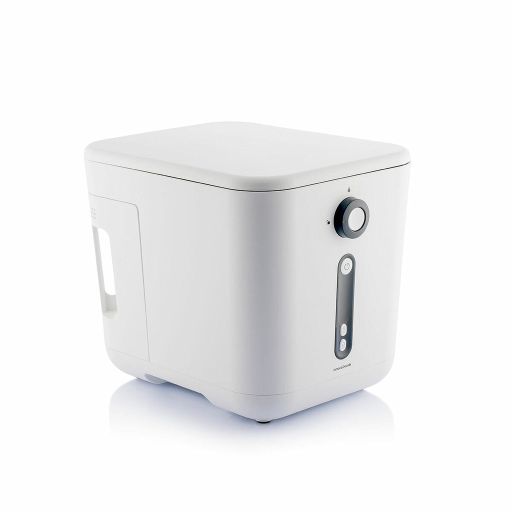 Side view of the Ewooster electric composter in a studio setting, showing its compact design.