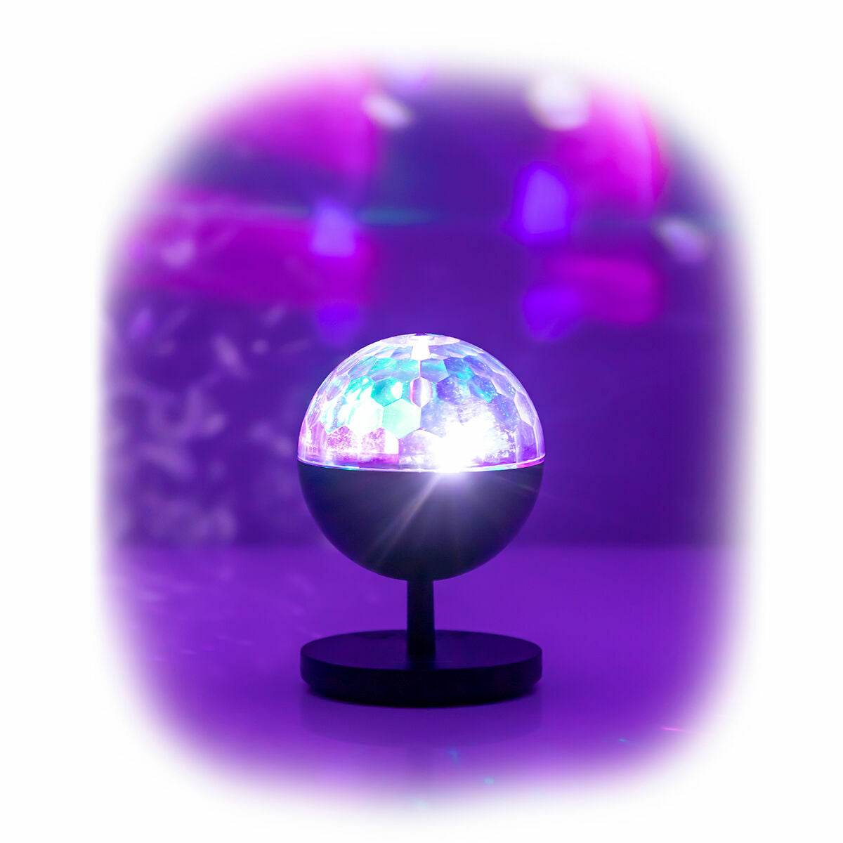 The LED projector is illuminated in a colorful purple glow, set in a minimalist environment, highlighting its light projection capabilities.