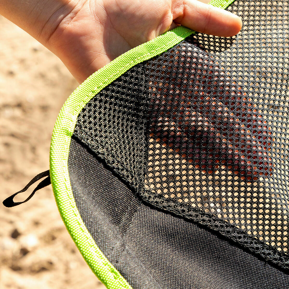A close-up detail shot of the chair's mesh fabric, showing the texture and quality of the material with lime green lining. This highlights the durability and design of the chair.