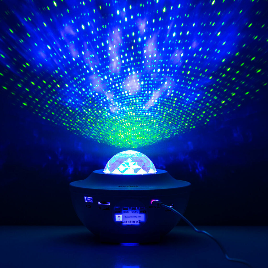 In a dimly lit bedroom, the projector casts blue and green stars, serving as a relaxing night light. An individual is asleep, showcasing its use as a comforting sleep aid.