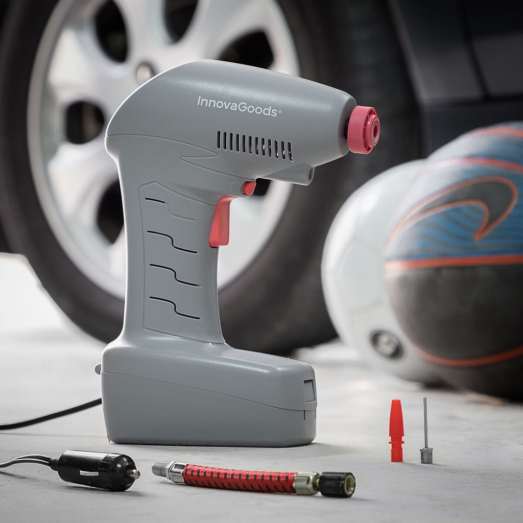 The air compressor next to a car tire and sports balls, emphasizing its applications. The product and its accessories are neatly arranged for emphasis on versatility.