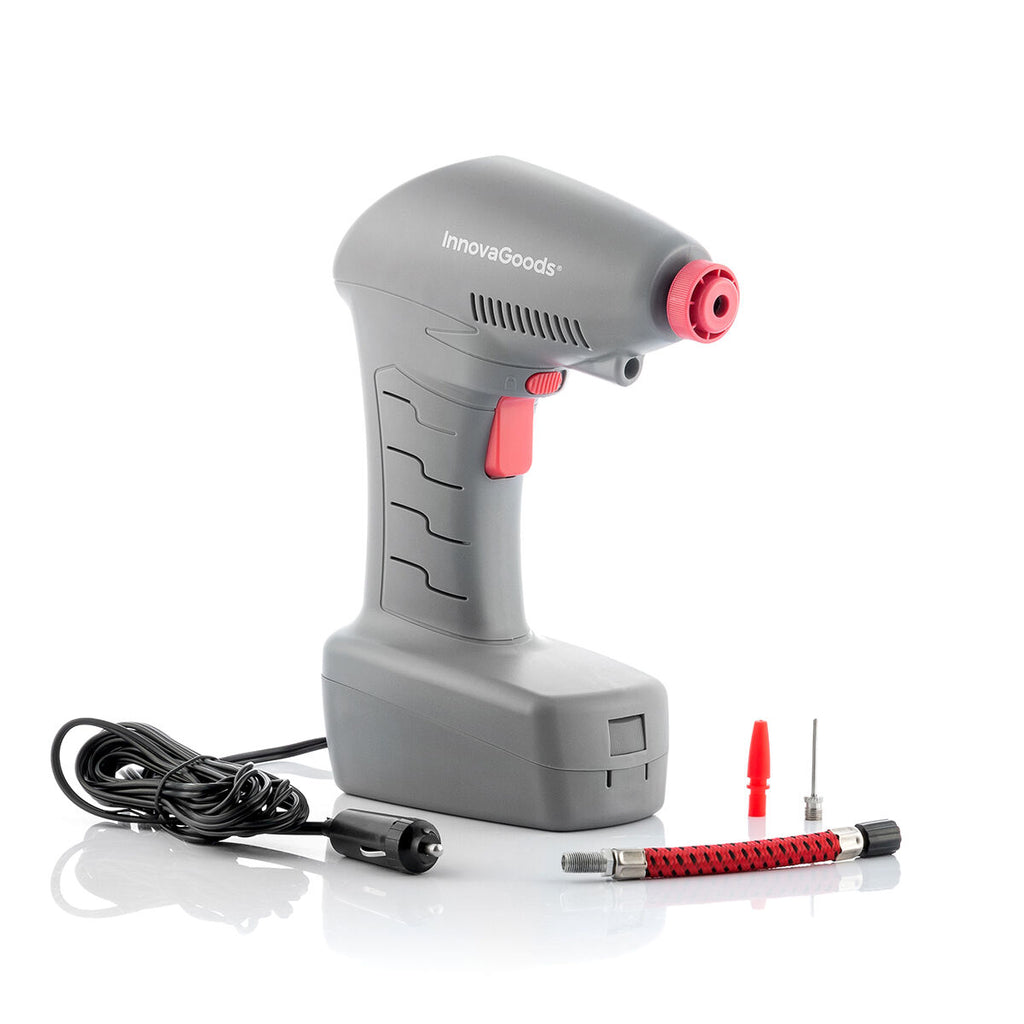 A clean product shot of the gray InnovaGoods portable air compressor with its accessories, including a power cable, hose, and nozzles, all placed on a white surface.