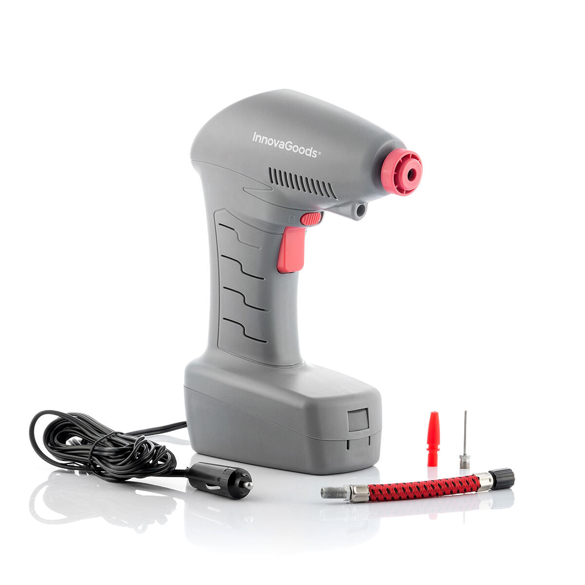 A clean product shot of the gray InnovaGoods portable air compressor with its accessories, including a power cable, hose, and nozzles, all placed on a white surface.