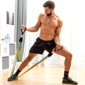 A male user exercising with resistance bands indoors. He stands on a wooden floor with bright lighting and modern decor.