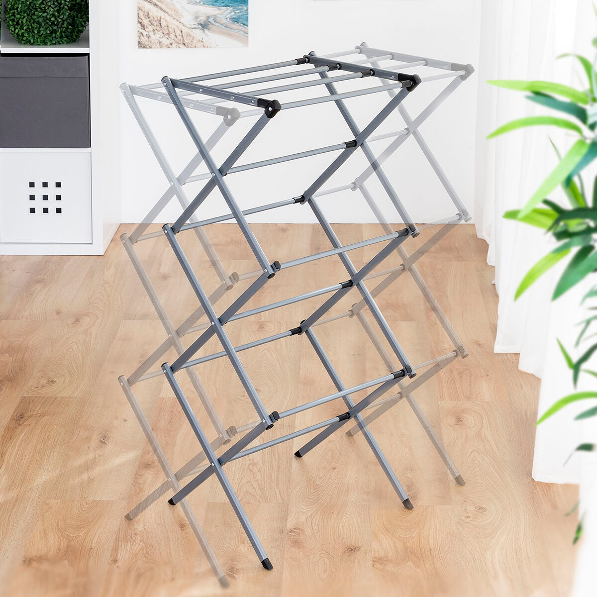 Transparent effect showing the different expandable positions of the metal clothes dryer in a room setting.