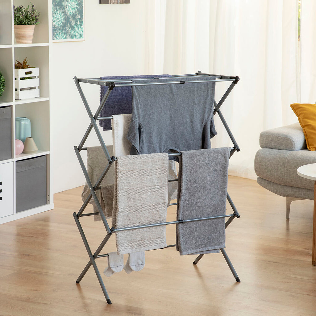 The clothes dryer fully extended in a living room setting with clothes hanging, enhancing the functional aspect in a homely context.