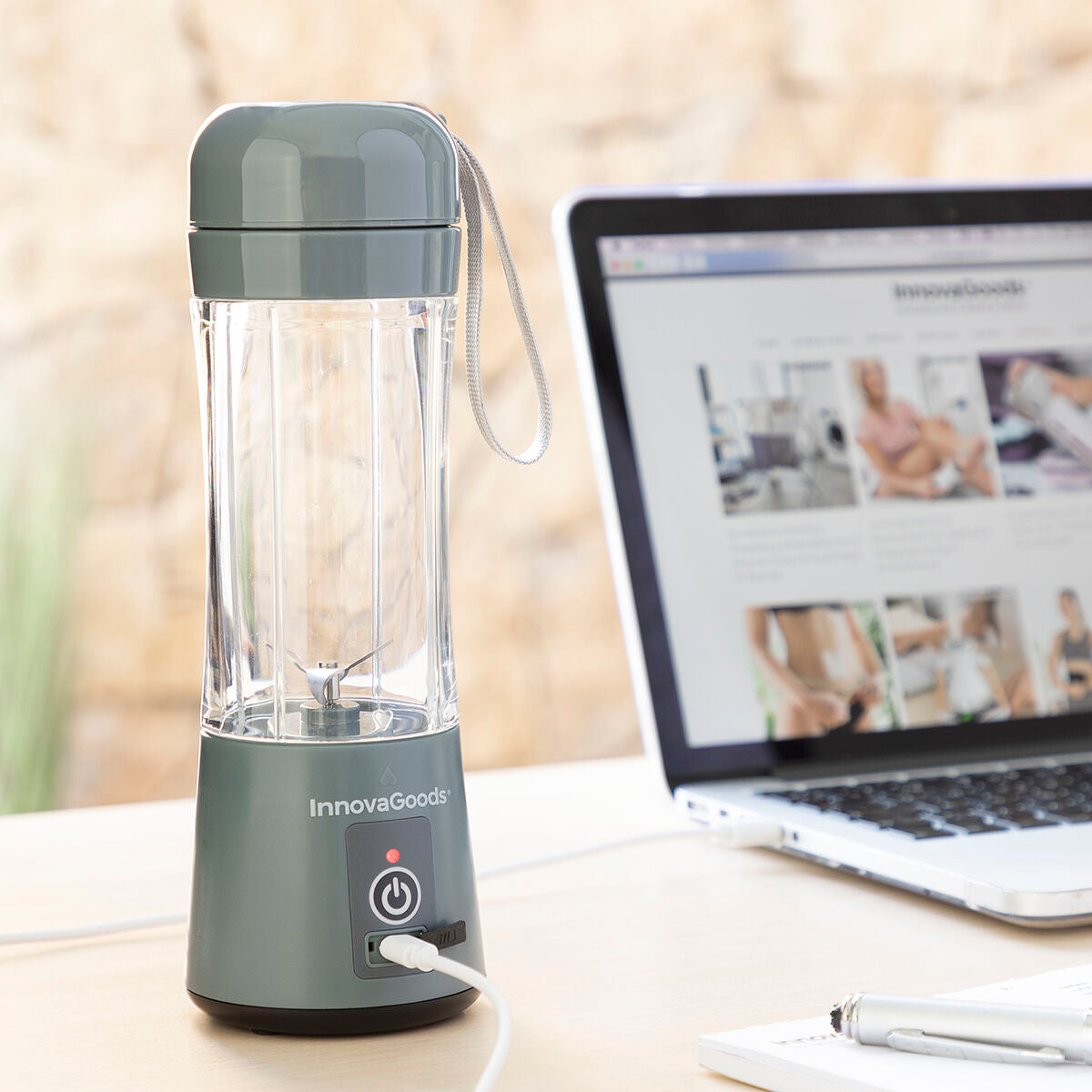An image of the blender being charged with a USB cable next to a laptop, demonstrating its convenient rechargeable feature for office or home use.
