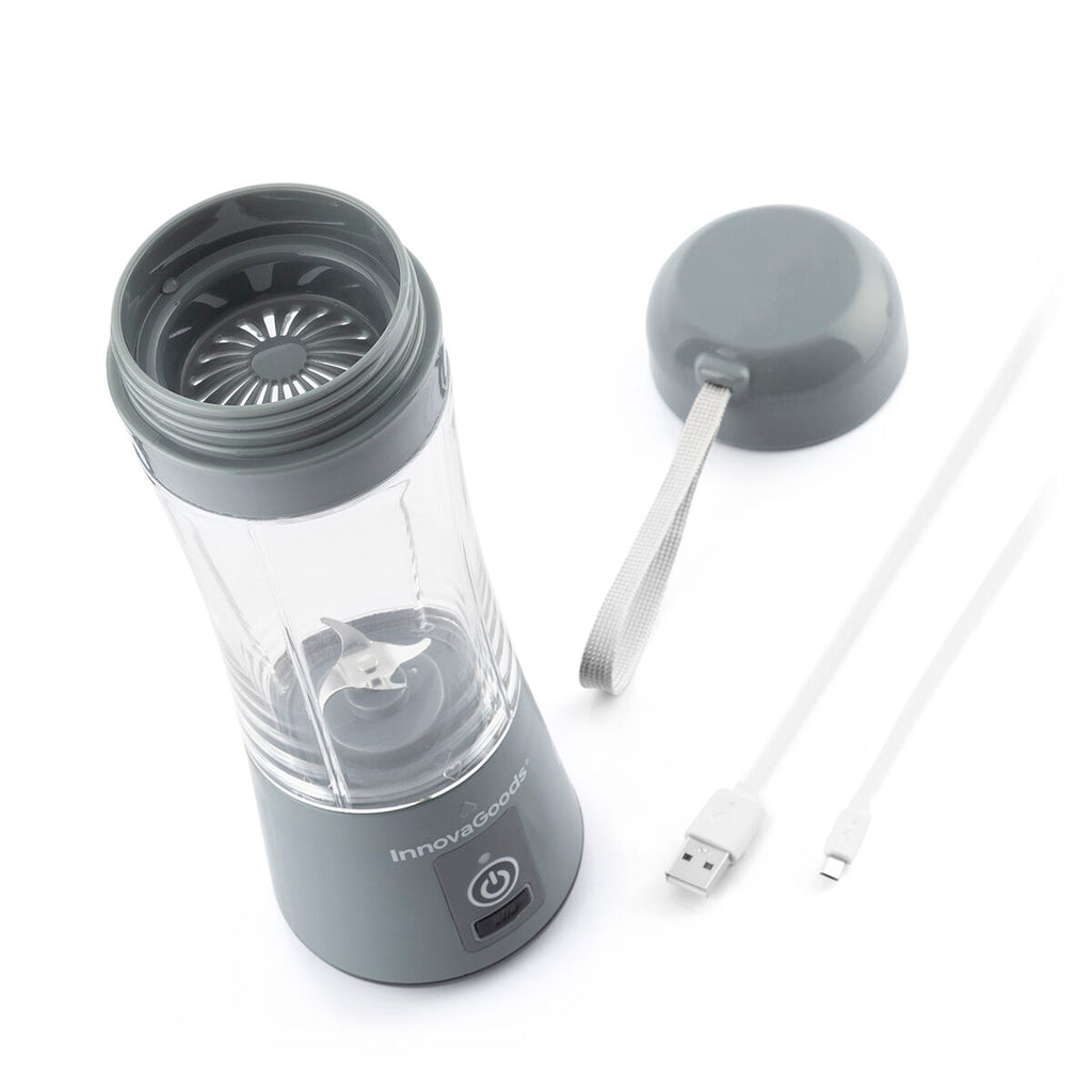 The blender is disassembled, showing the lid, blending cup, and USB charging cable, highlighting the product's portability and reusability features.