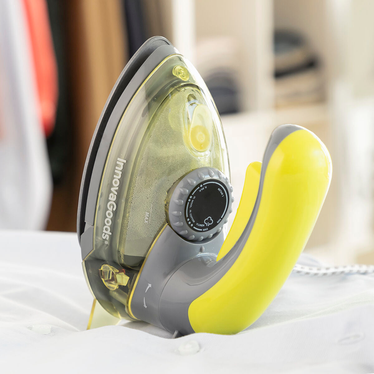 Close-up of the Mini Steam Iron in a home setting on an ironing board, emphasizing its compact size and ease of use.