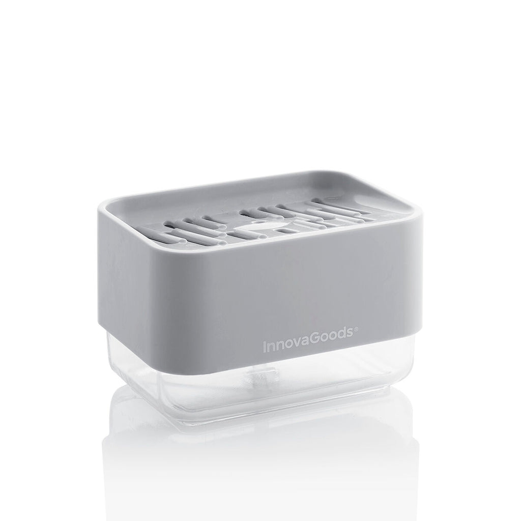 A clean product shot of the InnovaGoods Pushoap 2-in-1 Soap Dispenser against a white background. The gray top with the InnovaGoods logo and the clear bottom section are prominently displayed.