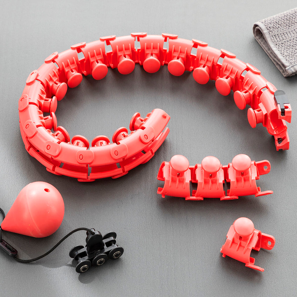 Close-up of the modular components of the Fittehoop on a flat surface, showcasing its vibrant red color and detachable nodes for easy adjustment.