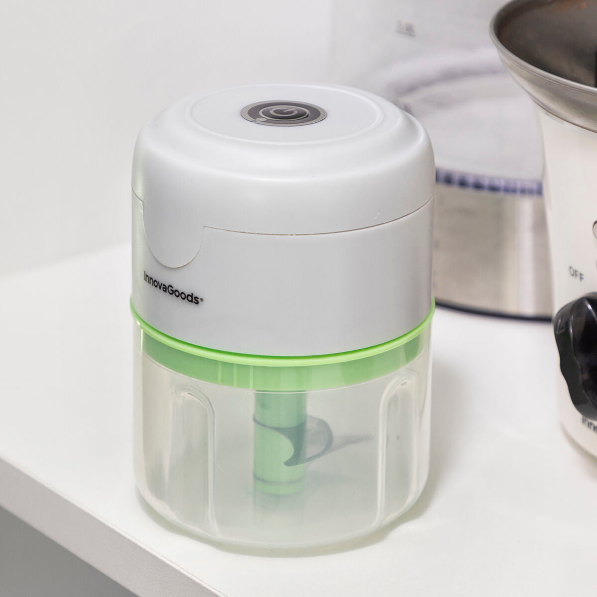 A close-up of the InnovaGoods mini chopper resting on a kitchen counter, showing its compact design.