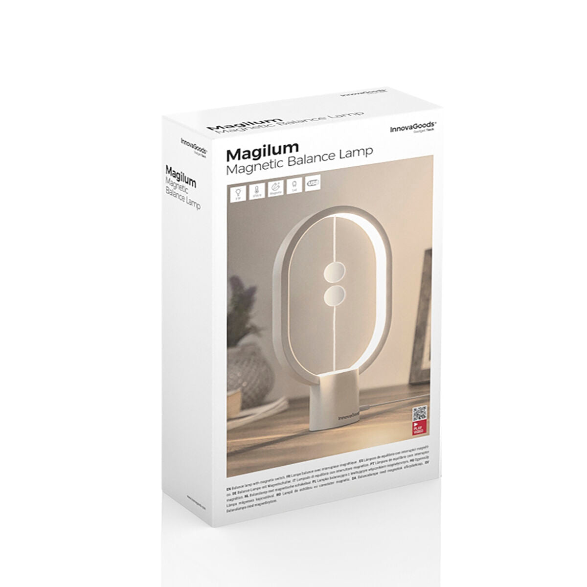 Packaging of the InnovaGoods Magilum Magnetic Balance Lamp. The box is white with an image of the lamp prominently displayed. The product name, Magilum Magnetic Balance Lamp, is clearly printed, along with branding and product details.