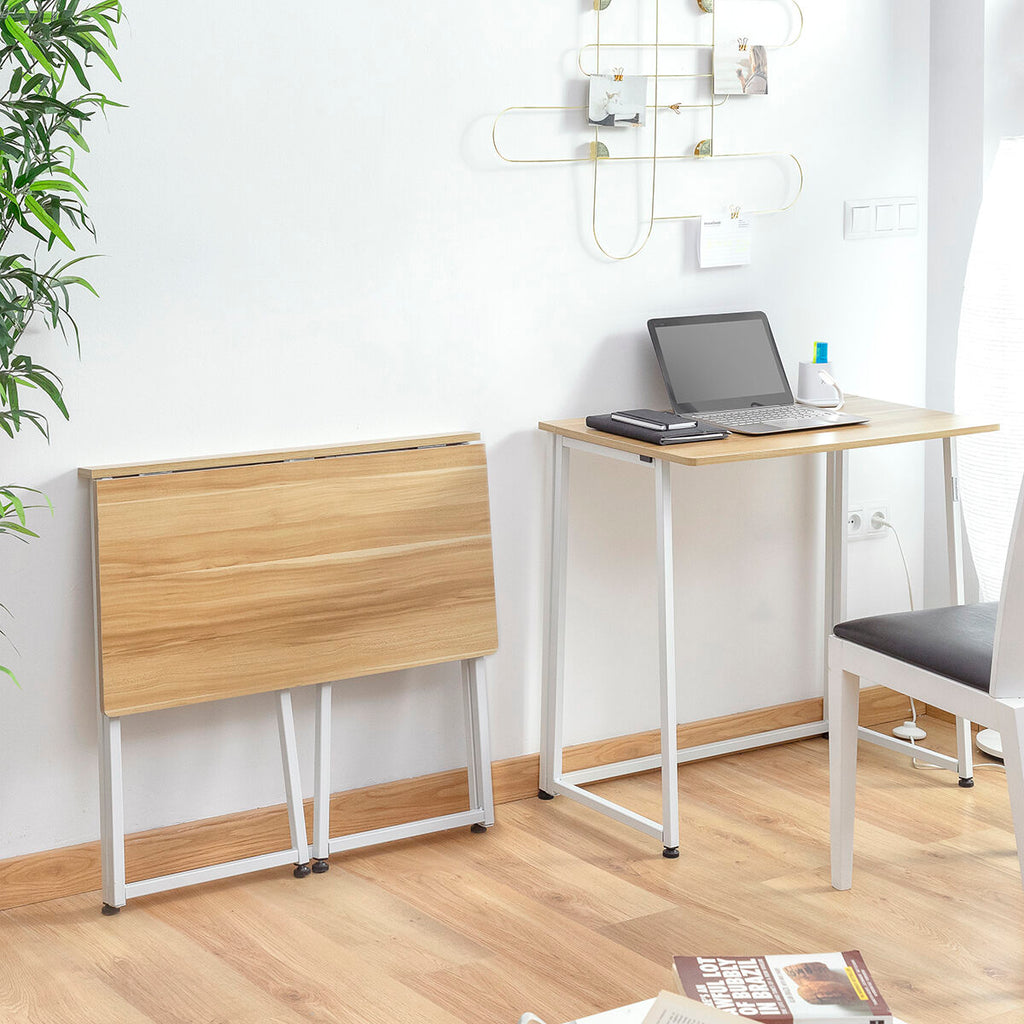Two desks with wooden tops and white metal legs set up in a study area with chairs and a laptop.
