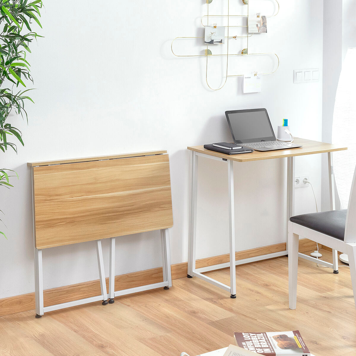 Two desks with wooden tops and white metal legs set up in a study area with chairs and a laptop.