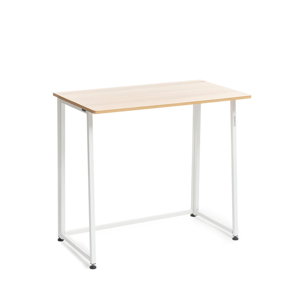 The desk unfolded, showcasing its wooden top and white metal legs in a minimalistic setting. The surface is clean and empty.