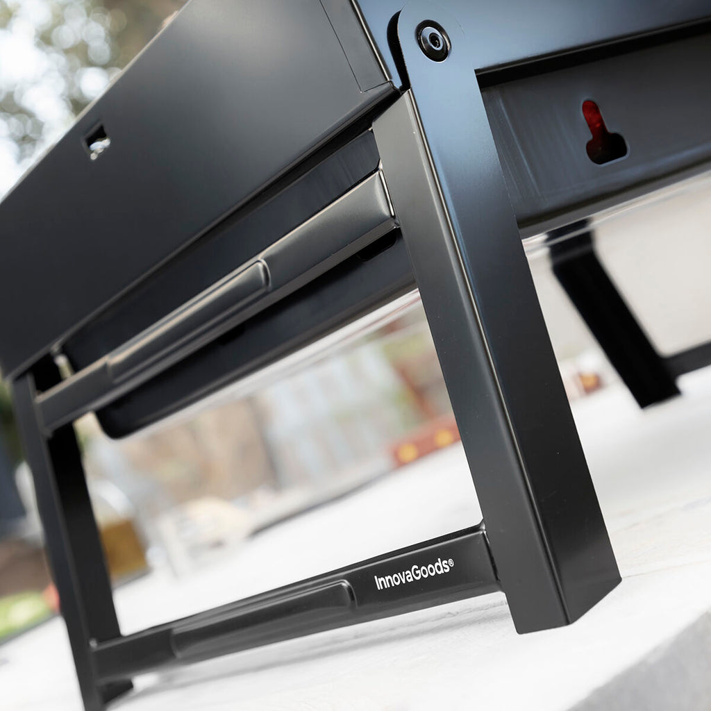 Close-up perspective shot of the grill's corner, highlighting the robust leg design and logo.
