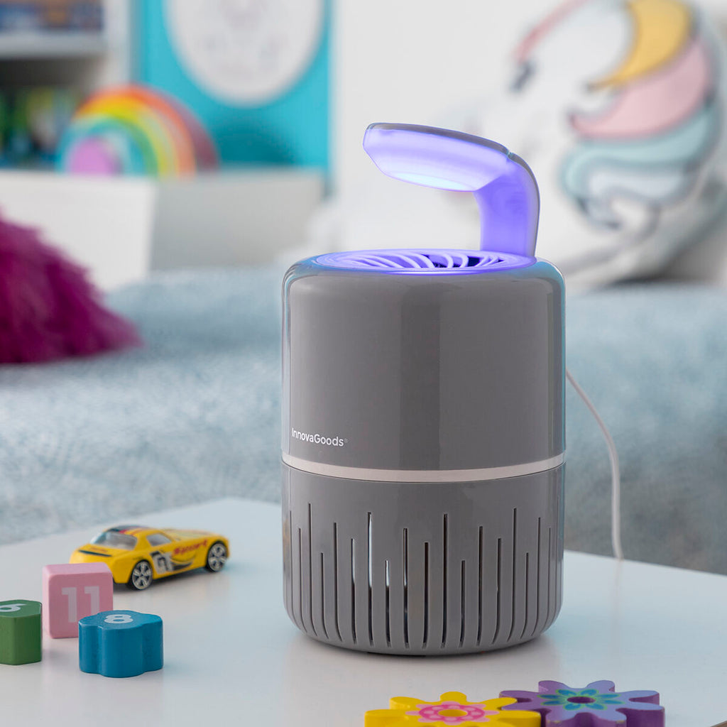 A lifestyle image showcasing the mosquito lamp in a child's room, surrounded by toys. The lamp is on a table, again emphasizing its role in maintaining a mosquito-free environment.