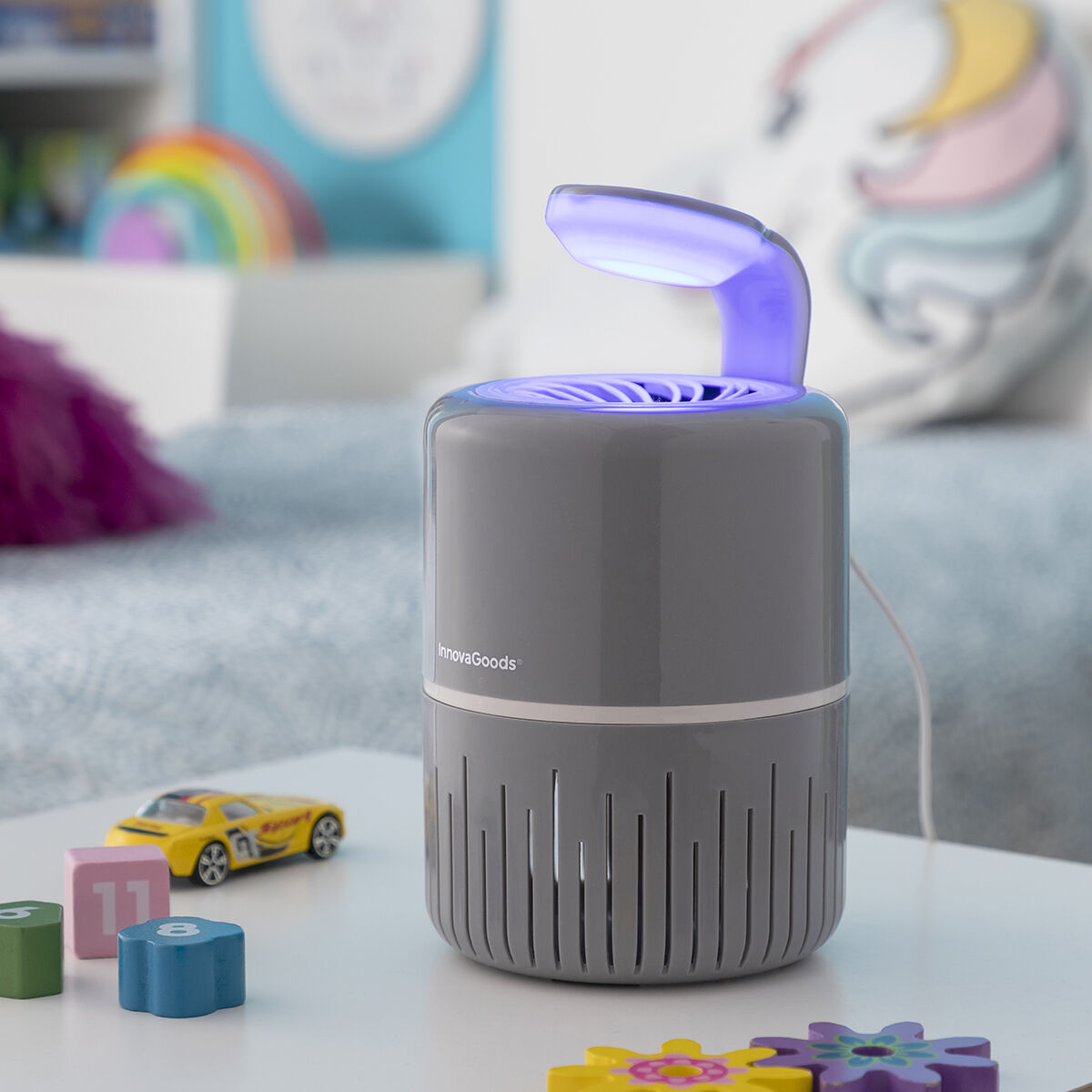 A lifestyle image showcasing the mosquito lamp in a child's room, surrounded by toys. The lamp is on a table, again emphasizing its role in maintaining a mosquito-free environment.
