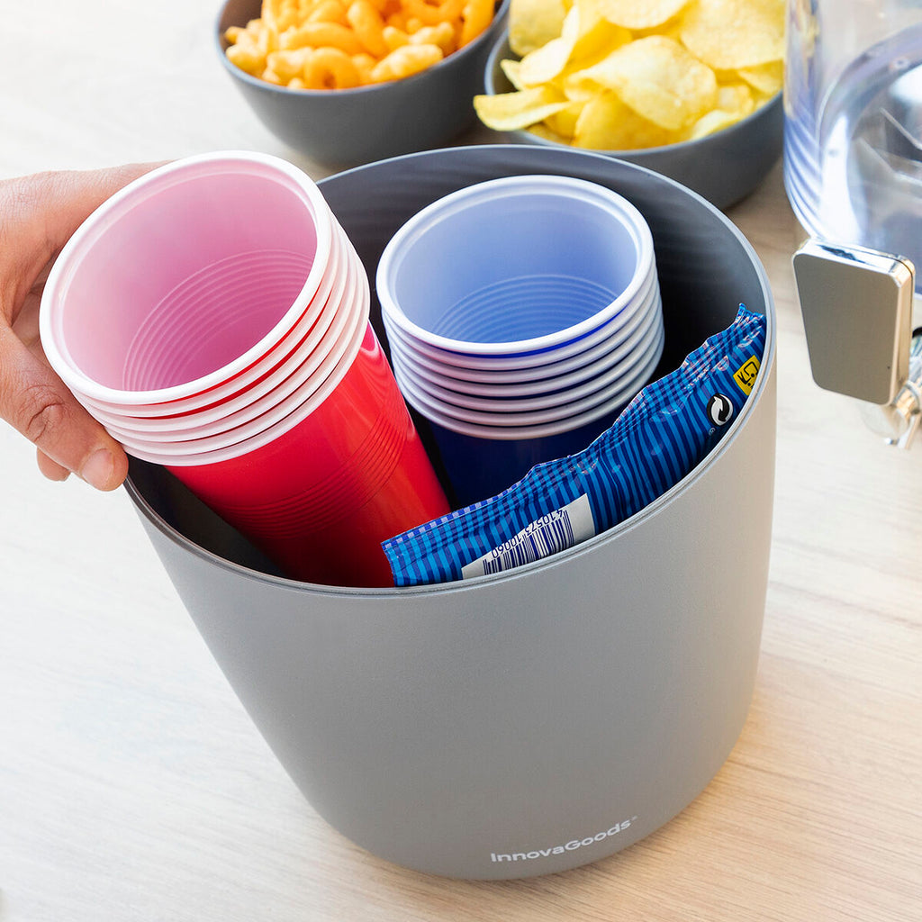 Close-up of the dispenser used for storing cups, indicating its versatility and additional storage feature.