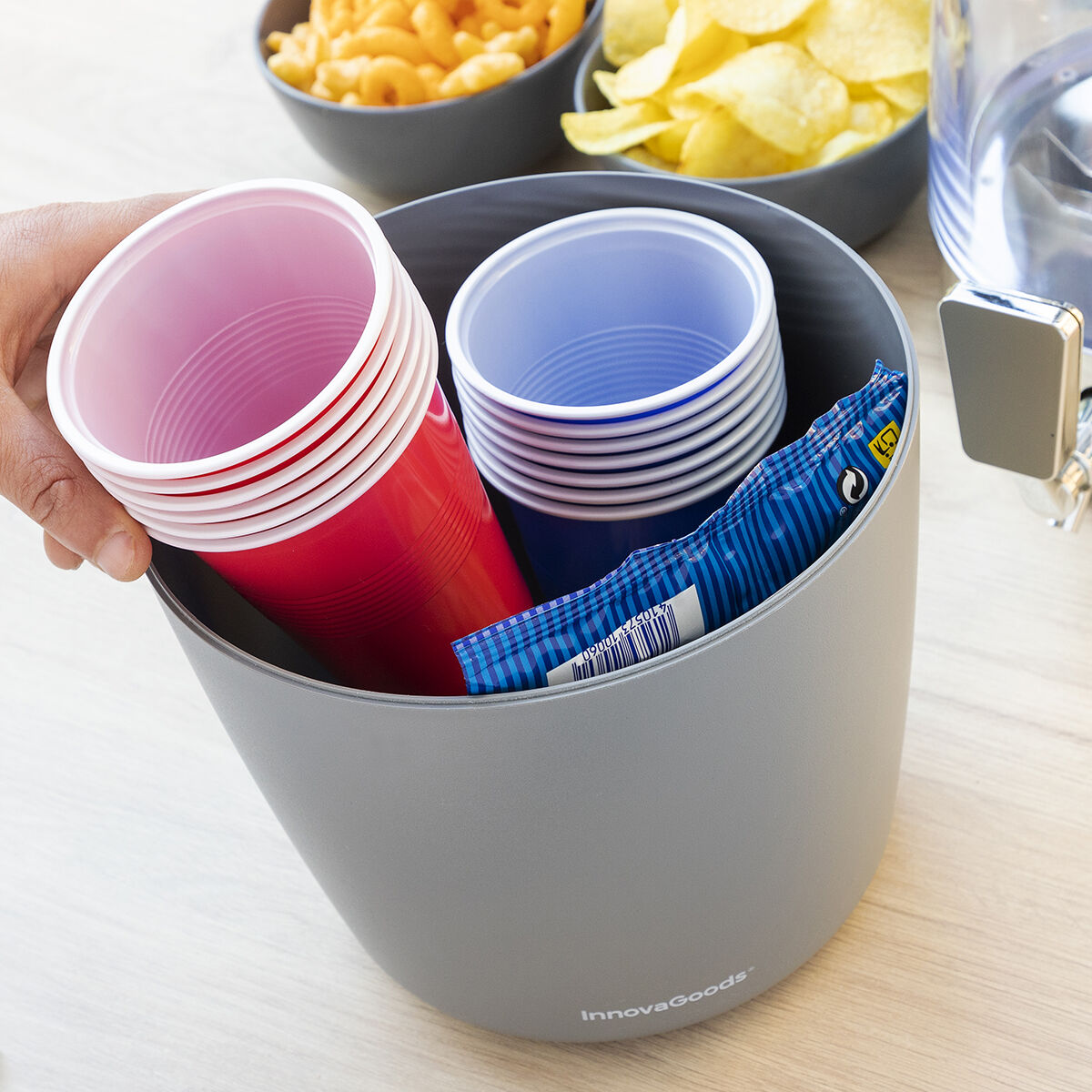 Close-up of the dispenser used for storing cups, indicating its versatility and additional storage feature.