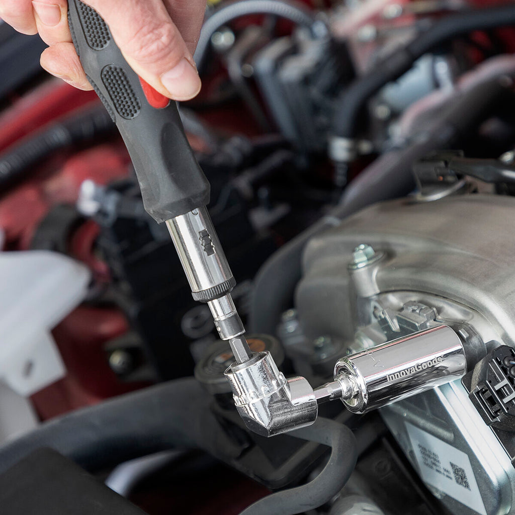 The tool in use for automotive repair, showing the socket wrench equipped on a hand tool in an engine compartment.