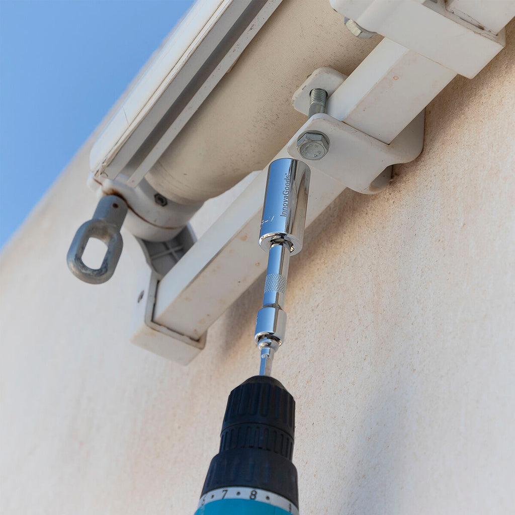 The socket wrench being used on a wall fixture, demonstrating versatility on different surfaces.