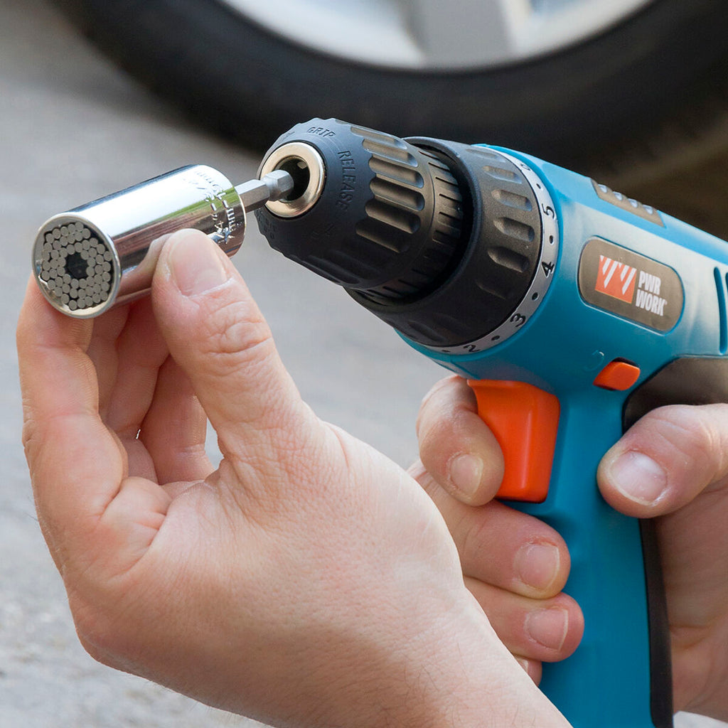 The socket wrench used with a drill, showing it in action unscrewing a bolt in a mechanical setting.