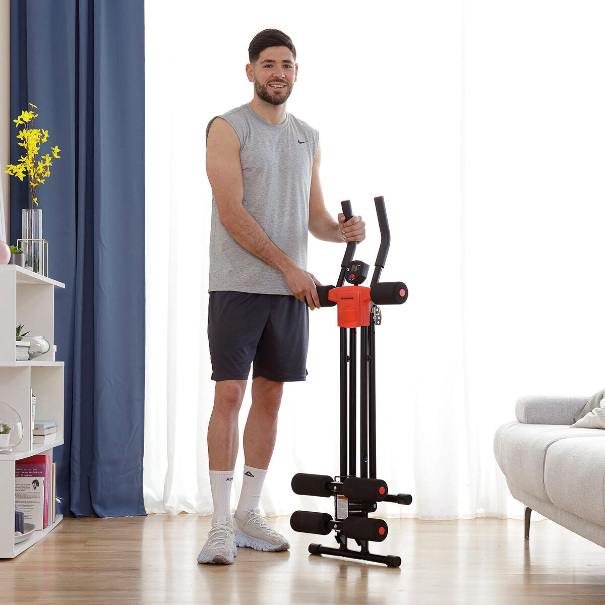A man standing and folding the machine. The image shows the machine's compactness and portability when folded up.