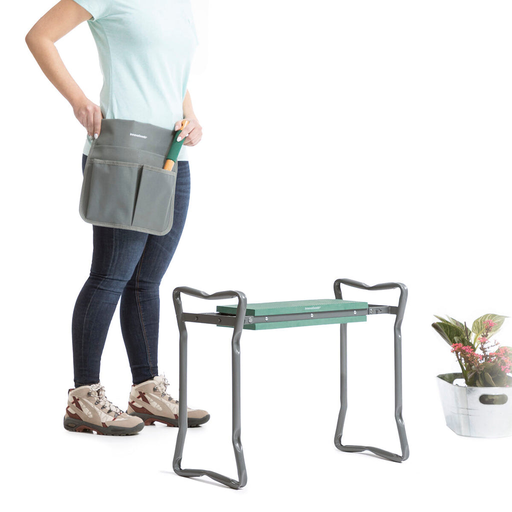Close-up of the green textured seat of the garden stool with garden tools laid on top.