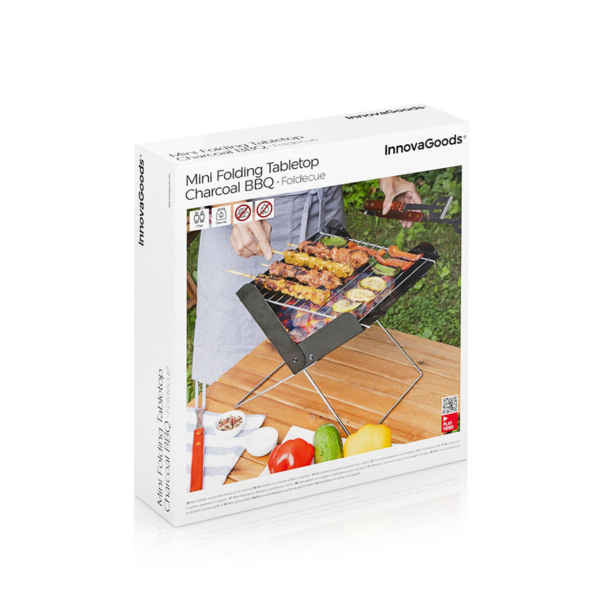 Packaging for the Mini Folding Tabletop Charcoal BBQ - Foldecue from InnovaGoods. The box features an image of the product in use, along with branding elements and a white background.