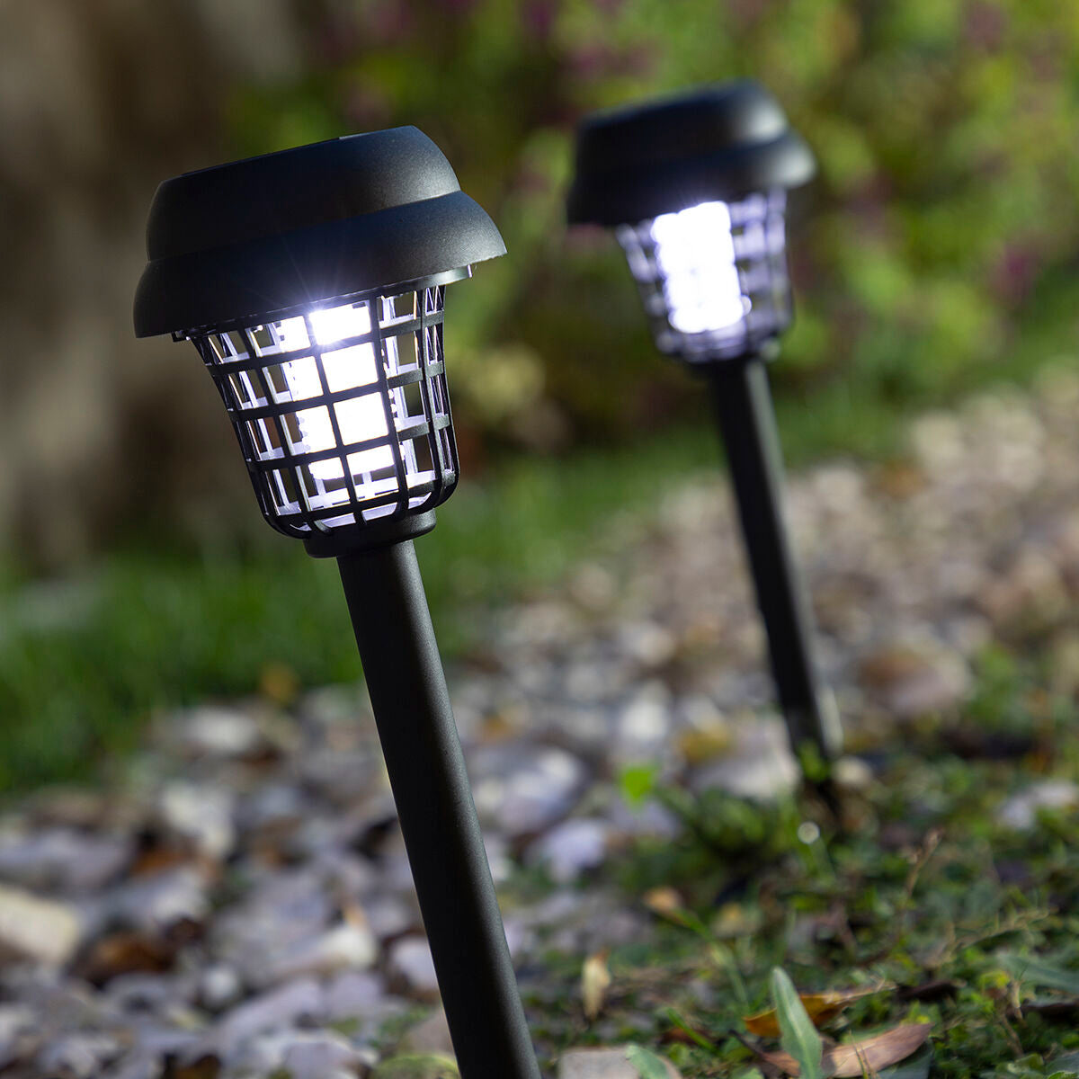 Top view close-up of the solar lamp head showing the solar panel prominently with sun reflections.