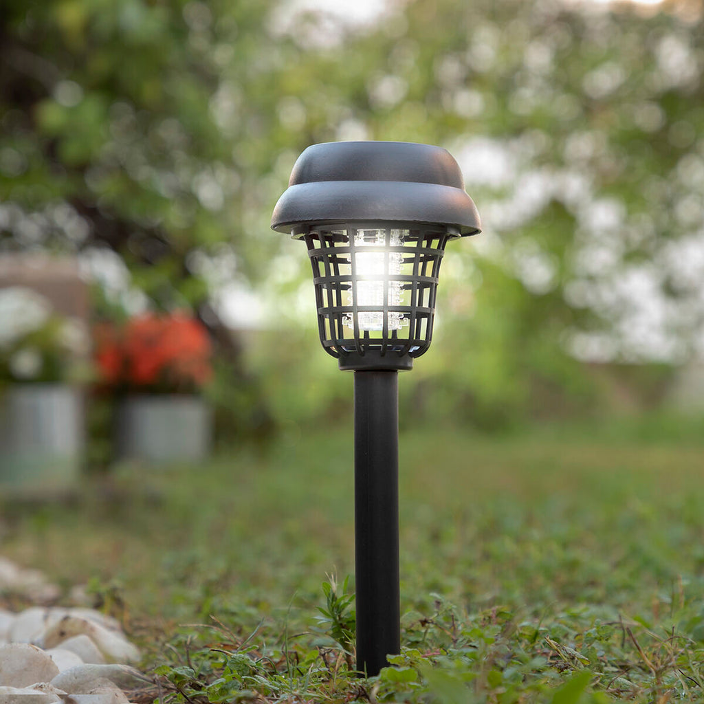 Close-up of the lamp head, wet from rain, illustrating its weather-resistant features.