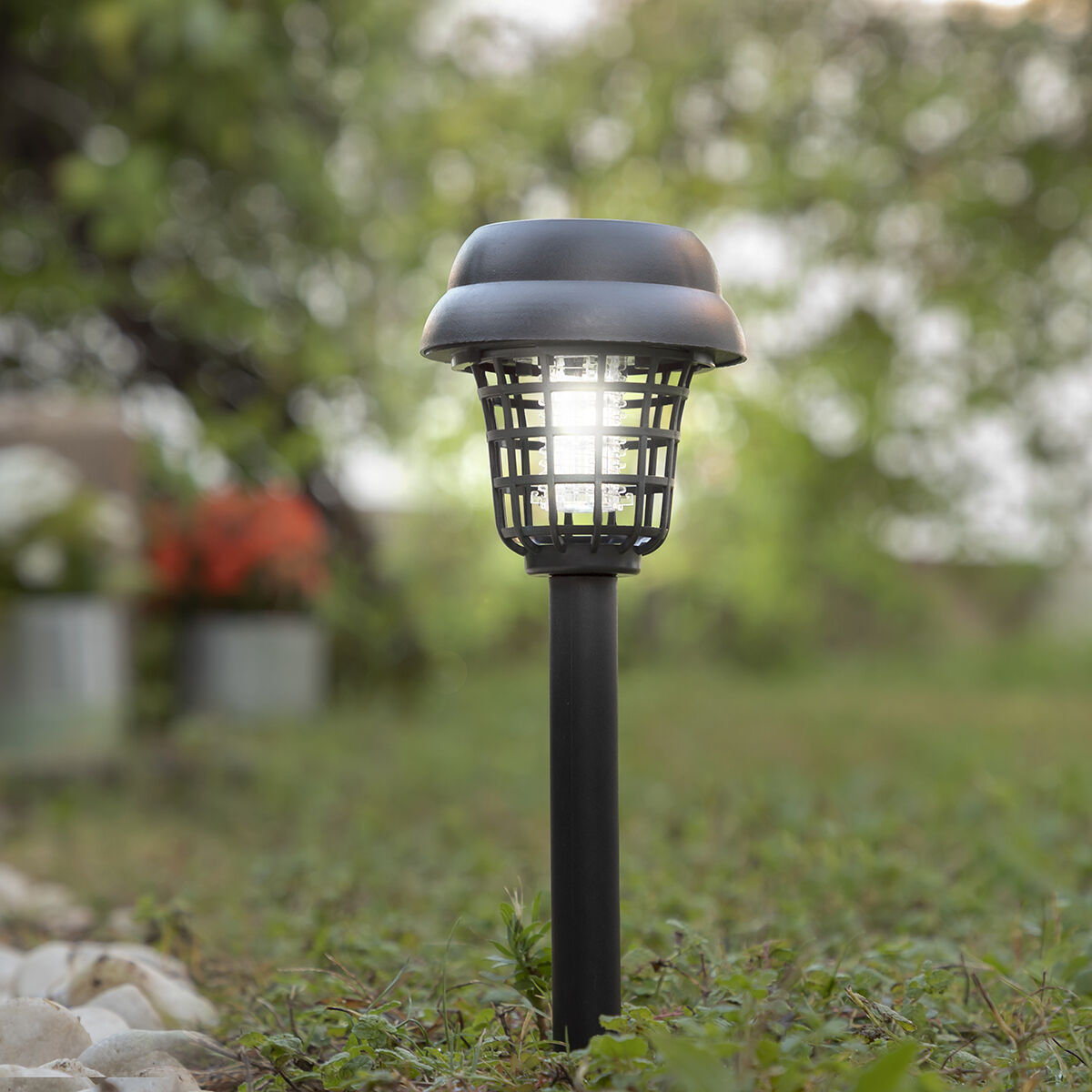 Close-up of the lamp head, wet from rain, illustrating its weather-resistant features.
