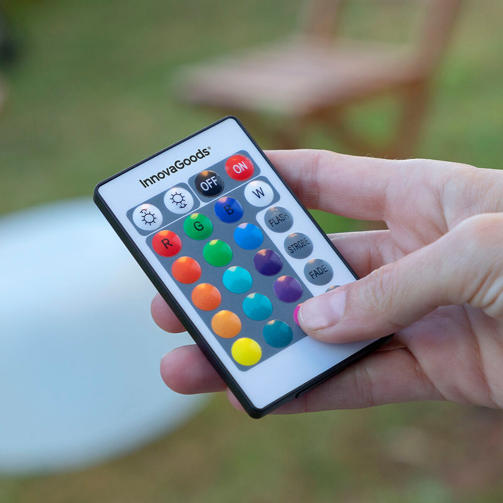 Close-up of the remote control for the inflatable LED seat with labeled multicolor buttons.