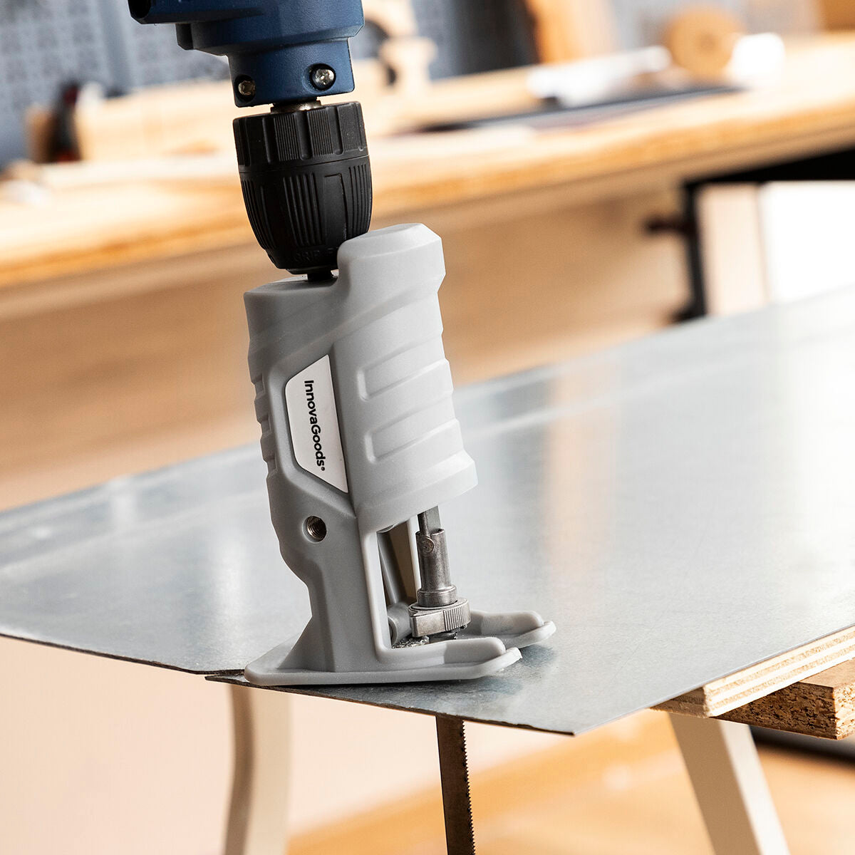 A vertical orientation showing the attachment cutting through a metal sheet in a workshop, with focus on product interaction and precision.