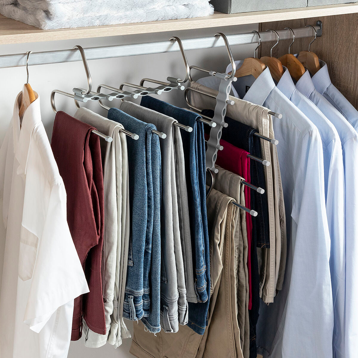 Full view of hanger with trousers hanging vertically in a closet, displaying maximum efficiency.