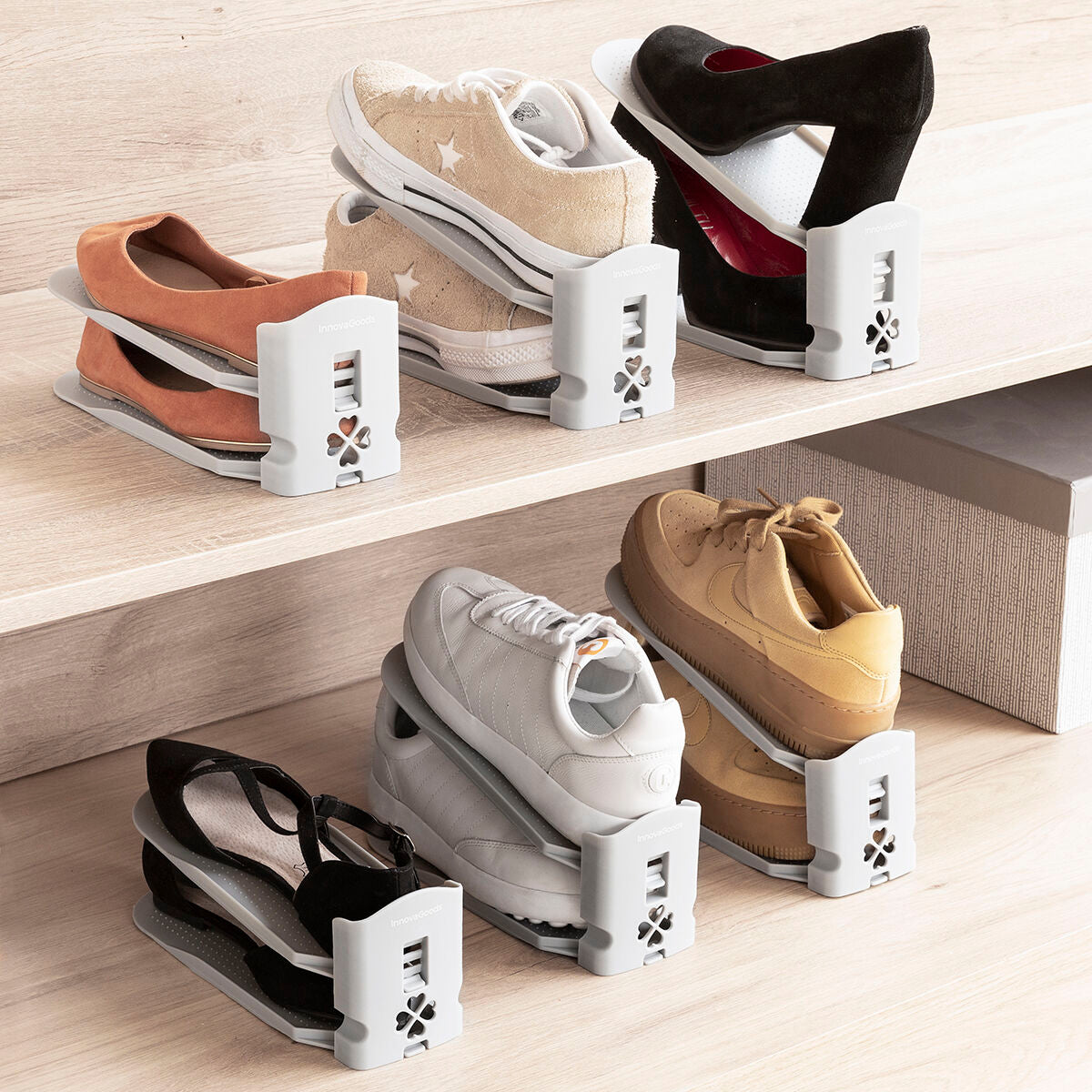 The image shows several shoe organizers in use, holding various types of shoes like sneakers and high heels. They are placed on wooden shelves, with each organizer in gray featuring an adjustable two-level design to maximize space efficiency.