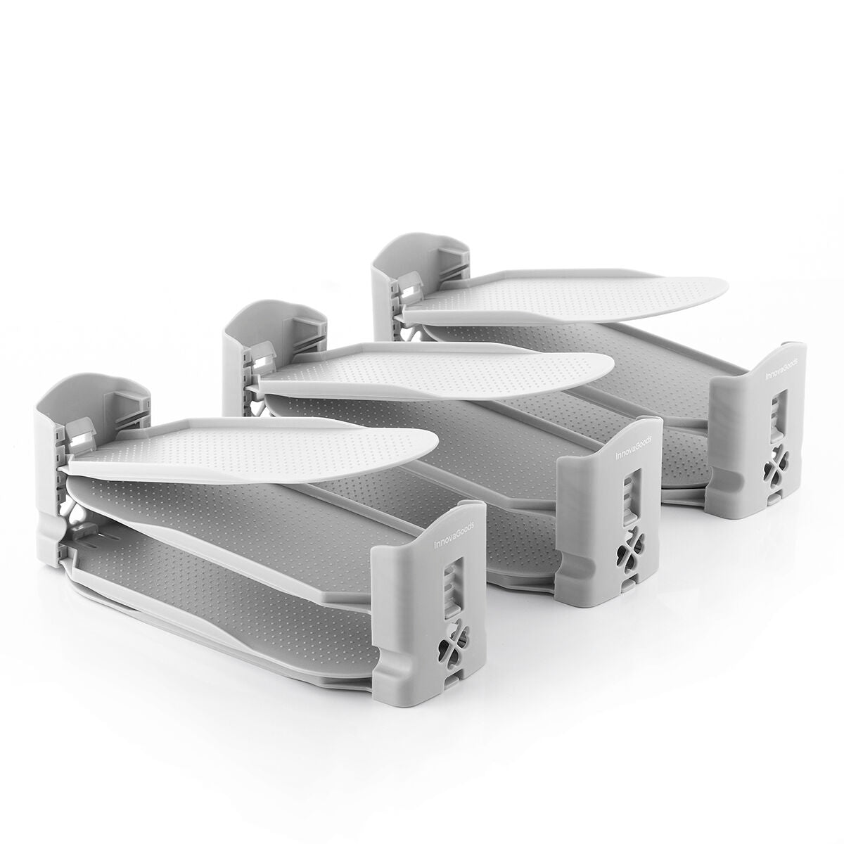 A clean product shot of multiple shoe organizers, highlighting their stackable feature with adjustable levels. The organizers are all gray and display the InnovaGoods brand, showing them in a pristine state for clear visualization.