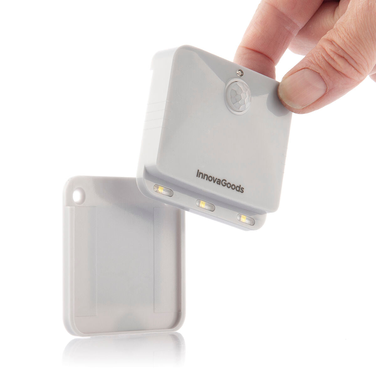 A close-up image of the LED light being detached from its base, showcasing the ease of handling and installation.