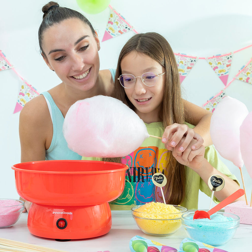 Another lifestyle image capturing a joyful scene with a woman and child making cotton candy using the machine. Vibrant colors and festive table settings enhance the scene.